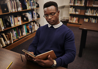 Image showing University, book and black man student reading and learning in a college for knowledge development. Serious, education and person studying research to prepare for exam or assignment in a class