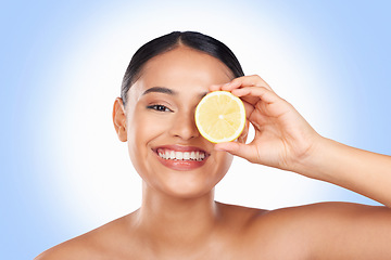 Image showing Skincare, studio portrait and happy woman with lemon for organic detox treatment, natural self care routine or facial cleaning. Vitamin C benefits, fruit and face of person smile on blue background