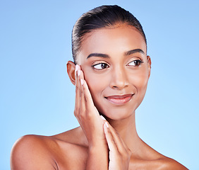 Image showing Beauty, wellness and skincare with face of woman in studio for cosmetics, dermatology and facial. Glow, self care and smile with person on blue background for spa treatment, grooming and makeup