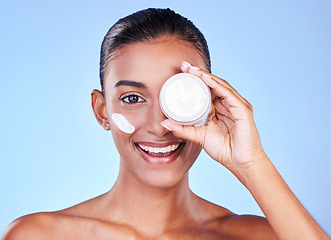 Image showing Skincare, cream and cosmetics with portrait of woman in studio for beauty, facial or moisturizer. Spa, health and collagen with face of person on blue background for product, glow or sunscreen
