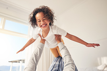 Image showing Airplane, happy and parent playing with child in a bedroom for bonding, fun and happiness together in a home. Weekend, laughing and kid flying in a fantasy game on a bed as a plane with father