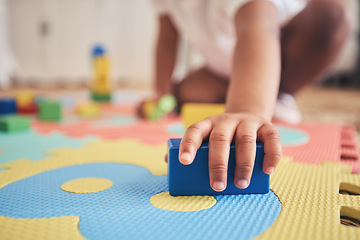 Image showing Building blocks, hands and toddler at daycare with development on number carpet and ground. Learning, baby and toy with nursery, motor skills and child game at kindergarten with youth and cube