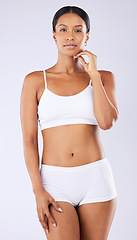 Image showing Portrait, diet and woman in underwear, self care and wellness on a white studio background. Person, healthy girl and model with workout, wellness or exercise with fitness, aesthetic and weight loss