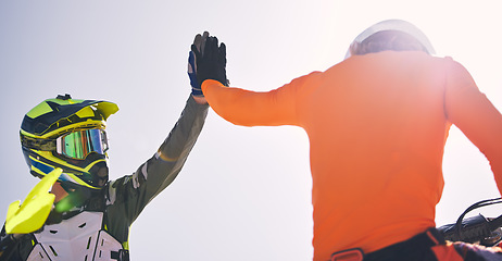 Image showing Motorcycle men, high five and outdoor for race, success or achievement with speed, goals and teamwork. Motorbike athlete, champion partnership and congratulations with helmet, safety and support