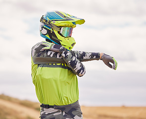 Image showing Motor sports, stretching and man with helmet in nature for training, workout and performance for race. Travel, motorbike and person outdoors ready for action for adventure, freedom and adrenaline