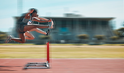 Image showing Fast, hurdles and team of women on track running in race, marathon or competition in stadium. Fitness, workout and female athletes jumping with speed and energy for outdoor training with blur motion.