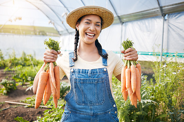 Image showing Greenhouse, portrait of happy woman holding carrots at sustainable small business in agriculture and natural organic food. Girl working at agro farm, vegetable growth in garden and eco friendly pride