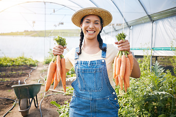 Image showing Farming, portrait of happy woman holding carrots at sustainable small business in agriculture and natural organic food. Girl working at agro greenhouse, vegetable growth and eco friendly with smile.