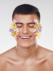 Image showing Floral, face or happy man with flowers for beauty, natural cosmetics or wellness in studio on white background. Nature aesthetic, smile or model laughing at eco friendly skincare or spring art design