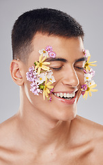 Image showing Cosmetics, man and eyes closed, flower pattern on face and skincare in studio for aesthetic, decoration and beauty on gray background. Smile, closeup and person with floral art for carnation and glow