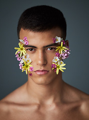 Image showing Face, man and flowers, beauty and natural, cosmetics and headshot with art deco isolated on studio background. Nature aesthetic, portrait and dermatology, eco friendly skincare and clean with spring