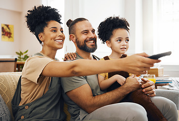 Image showing Interracial parents, child and watching tv on sofa, remote and choice for video, movie or show in living room. Father, mother and kid on lounge couch, comedy and streaming subscription in family home