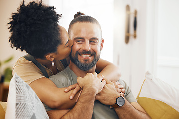 Image showing Interracial couple, hug and kiss, happy on couch and relax at home with bonding, commitment and affection. Healthy relationship, marriage and love with care and trust, people in lounge with romance