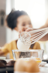 Image showing Whisk, egg and kitchen in closeup, kid and learning with muffins, cooking and helping hand from parents. Bowl, flour and child with development, teaching and baking with milk, cupcakes or family home