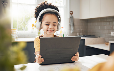 Image showing Tablet, headphones and child elearning in home, happy and online education for homeschool. Smile, technology and boy kid on video call, studying on internet and listening to music in virtual class
