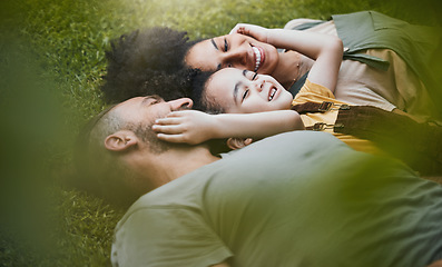 Image showing Care, happy and a family lying on the grass in nature for bonding, laughing and comfort. Love, smile and an interracial, father, mother and boy kid in a garden or backyard with an embrace together