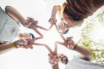Image showing Family, hands together and star fingers outdoor in low angle, happy and bonding. Father, mother and child huddle in love, solidarity and interracial support in cooperation, connection and success