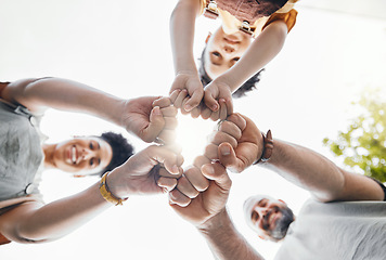 Image showing Family, fist bump and circle outdoor together in low angle, happy and bonding. Father, mother and child hands in huddle to love, solidarity and parents support in cooperation, connection and success