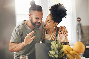 Image showing Interracial couple, video call and happy with laptop, wave hello and smile in kitchen, home and web chat. Excited man, young woman and contact with computer, webinar and talking with app in apartment