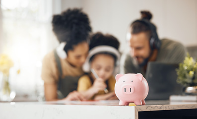 Image showing Piggy bank, table and parents with kid, learning or writing with headphones, online course or saving advice. Mom, dad and child for education, investment or help for future in interracial family home