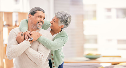 Image showing Happy, hug and senior couple in a living room with love, connection and conversation in their home together. Love, smile and old people embrace in a house with romance, speaking or bond in retirement