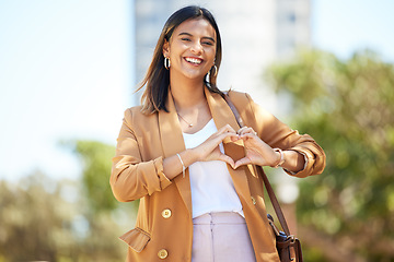 Image showing Portrait, city and woman with heart sign, business and travel with support, emoji and kindness. Person, employee and worker with gesture, social media and outdoor with symbol for love, care and icon