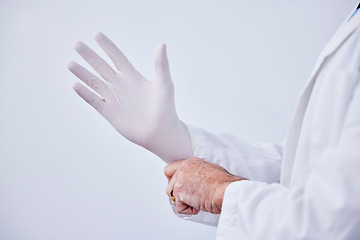 Image showing Doctor, hand and glove for medical or health care with hygiene, medicine and wellness in studio. Closeup of a professional person with ppe for safety, protection and insurance on a white background