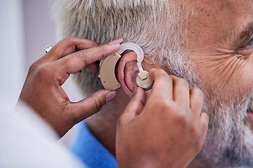 Image showing Healthcare, hands and doctor with hearing aid for man for communication support. Closeup, medical and a nurse with an implant for a patient with a disability for help with listening and conversation