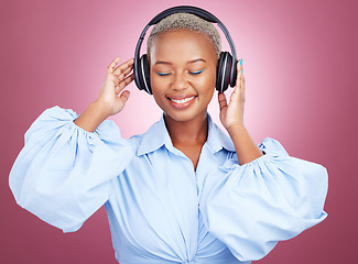 Image showing Music, headphones and happy black woman in studio for radio, streaming or audio subscription on pink background. Podcast, earphones and African lady model smile for album track or feel good playlist