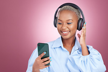 Image showing Music, headphones and black woman with phone in studio for streaming, radio or listen on pink background. Smartphone, app and African lady model with online audio, podcast and earphones for album