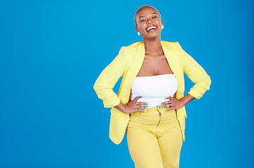 Image showing Portrait, fashion and mockup with a black woman laughing on a blue background in studio for marketing. Smile, space and funny with a young confident person posing hands on hips for advertising