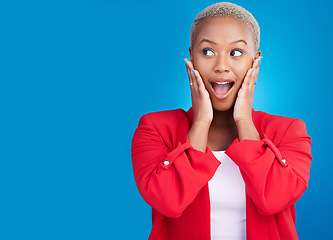 Image showing Hands on face, surprise and a woman in studio for wow advertising, marketing or announcement. Happy emoji of an excited African person on a blue background for news, mockup space or fashion promotion