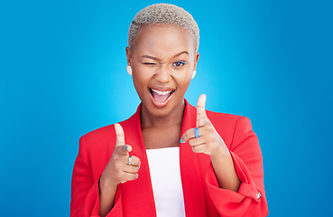Image showing Portrait, wink and finger guns with a black woman on a pink background in studio for choice or fun. Face, smile or comedy and an excited young model pointing with a hands emoji to vote as a winner
