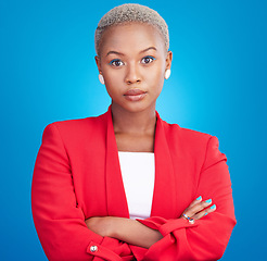 Image showing Beauty, crossed arms and serious black woman in a studio with cosmetic, self care and facial routine. Makeup, confidence and portrait of African female model with cosmetology face by blue background.