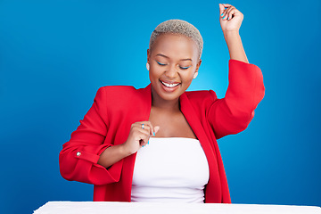 Image showing Dancing, happy and a woman in studio with fun energy for celebration, good news or fashion. Excited African person on a blue background to celebrate success, positive attitude and dancer moves