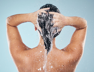 Image showing Shower, shampoo or woman cleaning hair for wellness or healthy head in studio on blue background. Cosmetics, beauty model or back of wet person washing or grooming for natural hygiene to relax