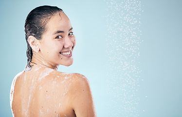 Image showing Shower, mockup or happy woman cleaning back, hair or body for wellness or skincare on blue background. Smle, space or wet person washing and grooming for healthy natural hygiene or beauty to relax