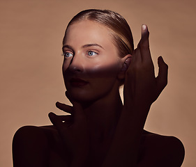 Image showing Spotlight, face or woman in shadow with beauty and creative aesthetic in studio background. Light on eyes, person or elegant model with dark side, art or style thinking of skincare, glow or cosmetics