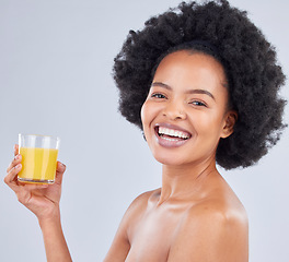 Image showing Woman, portrait and glass of orange juice in studio for vitamin c benefits on gray background. Face, happy african model and drink citrus fruit smoothie for healthy nutrition, diet and natural beauty