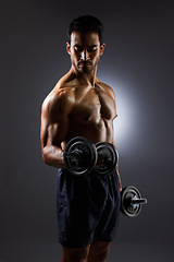 Image showing Muscle, strong and studio man with dumbbell challenge results, arm workout development and body fitness progress. Dark shadow, gym equipment and sports athlete with training focus on grey background