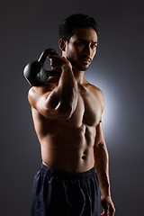 Image showing Training, studio portrait and man with kettlebell challenge, workout and fitness determination, motivation or weightlifting transformation. Gym equipment, athlete focus and person on grey background