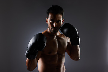 Image showing Boxing, studio portrait and sports man with fitness challenge motivation, gym club commitment and fight power workout. Dark shadow, boxer training exercise and strong MMA athlete on grey background