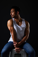 Image showing Relax, muscle and sexy man on chair in studio with fitness inspiration, beauty aesthetic and sensual fashion. Erotic art, sexual body and male model on black background, thinking with dark lighting.