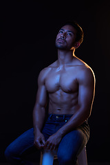 Image showing Topless, sexy and man in neon studio for fitness inspiration, beauty aesthetic or sensual fantasy. Erotic art, sexual body and male model thinking with muscle, black background and dark blue lighting