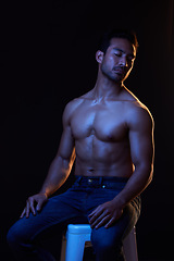 Image showing Topless, sexy man in dark studio for fitness inspiration, beauty aesthetic or sensual fantasy. Erotic art, sexual body and seductive male model with muscle, black background and neon blue lighting.