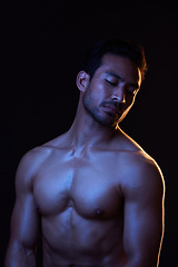 Image showing Topless, dark and sexy man on black background in fitness inspiration, beauty aesthetic or strong fantasy. Bodybuilder art, body and seductive male model with muscle, studio and neon blue lighting