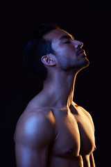 Image showing Topless, dark and sexy man in studio in fitness inspiration, beauty aesthetic or sensual fantasy. Erotic art, sexual body and seductive male model with muscle, black background and neon blue lighting