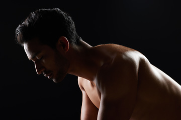 Image showing Exercise, strong and studio man doing push up challenge, gym fitness routine and workout for muscle building. Dark shadow light, body training development and calm sports athlete on black background