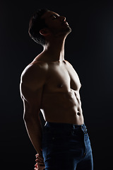 Image showing Bodybuilder man, shirtless and studio profile with wellness, healthy body and black background. Young guy, fitness and silhouette in dark, thinking and strong with ideas, health and topless for art