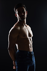 Image showing Bodybuilder man, shirtless and muscle in studio for wellness, healthy body and black background. Young guy, fitness and silhouette in jeans, portrait and strong for fashion, health or topless for art